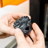 Oligomers for Toughness, Hands Holding A Model of Teeth