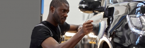 Bomar abrasion resistance materials, man conducting body work on a car